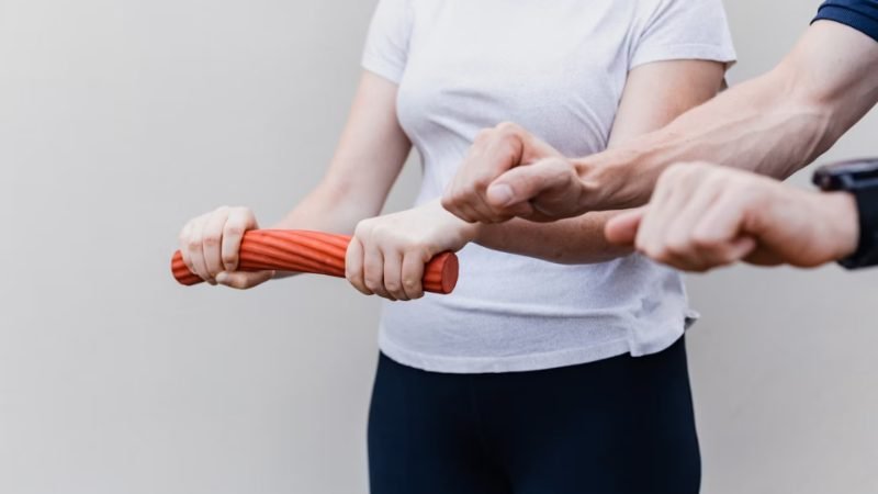 Patient practicing a resistance exercise with a therapist’s guidance